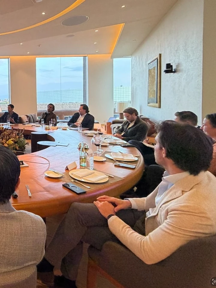 Members seated around the round table, place settings and a floral centrepiece in view, at the inaugural WRE Circle gathering in Mexico City